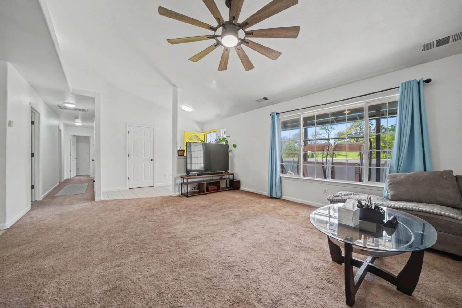 7761 Jenny Lind Road Valley Springs, CA 95252 - Photo 7 of 35 a view of a livingroom with furniture and a ceiling fan