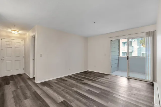 a view of wooden floor and windows in a room