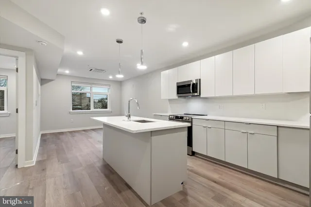 a kitchen with a sink window and cabinets