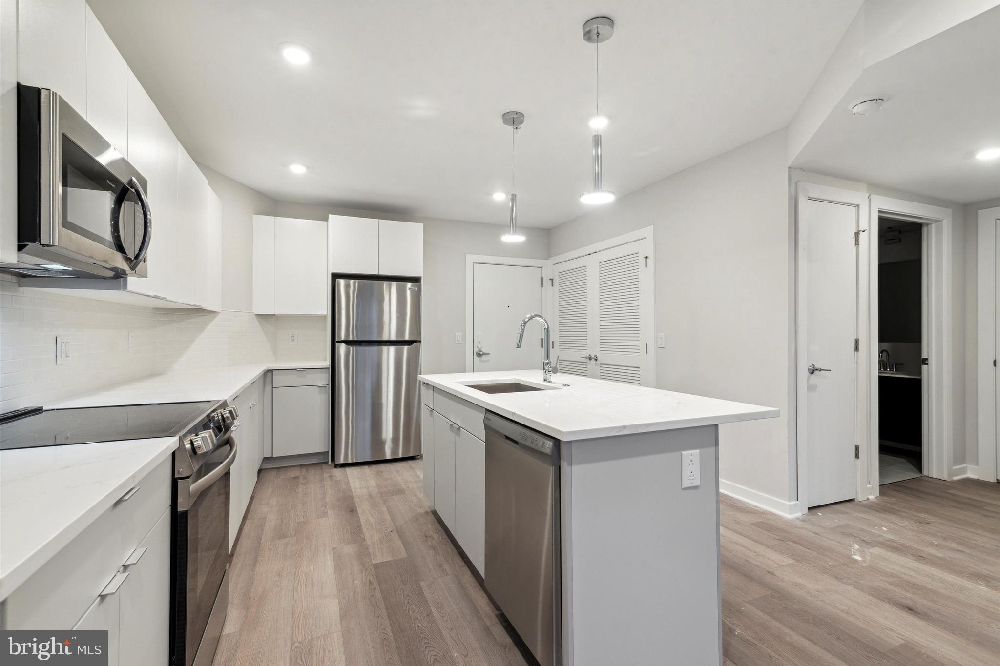 3449 Scotts Lane, Unit B303 Philadelphia, PA 19129 - Photo 3 of 9 a kitchen with a sink appliances and cabinets