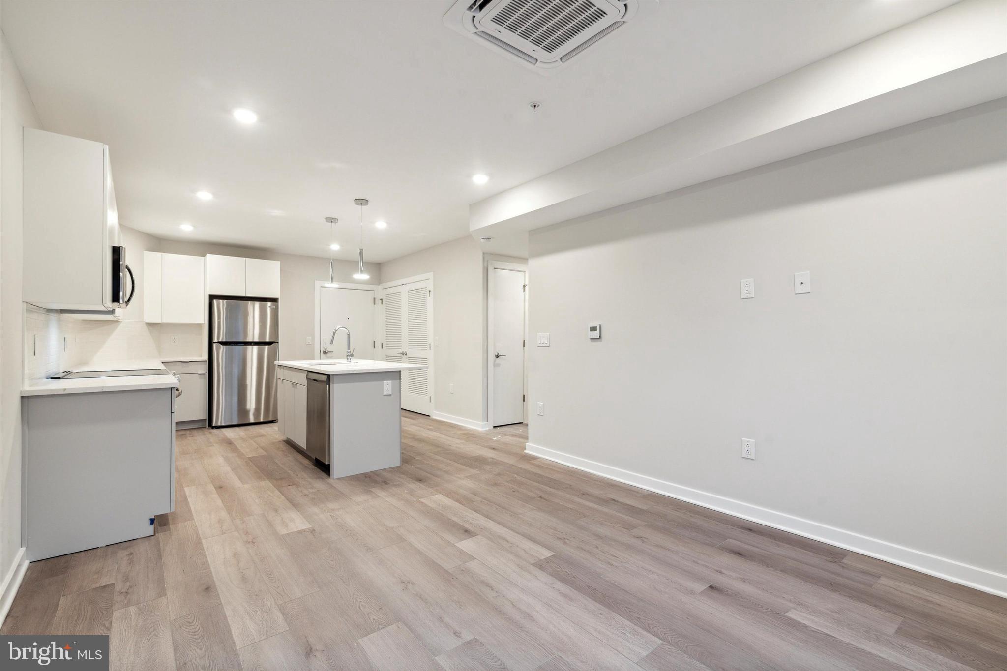 3449 Scotts Lane, Unit B303 Philadelphia, PA 19129 - Photo 7 of 9 a view of kitchen view wooden cabinets and stainless steel appliances
