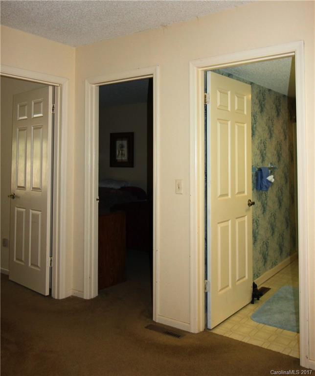 303 Riddle Cove Road, Unit 330 Maggie Valley, NC 28751 - Photo 13 of 24 a view of a hallway with wooden floor