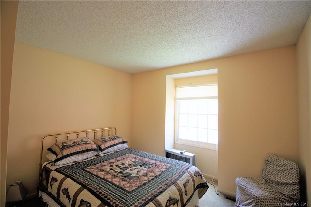 303 Riddle Cove Road, Unit 330 Maggie Valley, NC 28751 - Photo 15 of 24 a bed sitting in a bedroom next to a window
