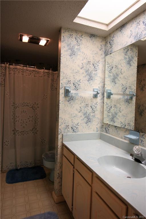 303 Riddle Cove Road, Unit 330 Maggie Valley, NC 28751 - Photo 16 of 24 a bathroom with a sink and a shower