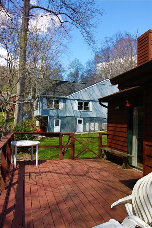 303 Riddle Cove Road, Unit 330 Maggie Valley, NC 28751 - Photo 17 of 24 a view of backyard with a patio and a garden