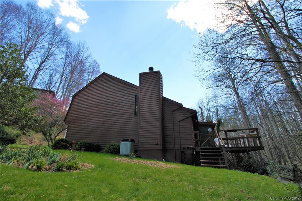 303 Riddle Cove Road, Unit 330 Maggie Valley, NC 28751 - Photo 3 of 24 a backyard of a house with lots of green space
