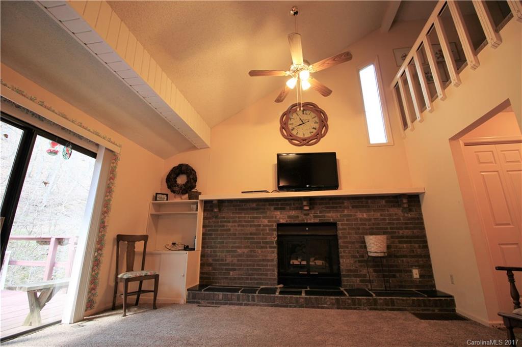 303 Riddle Cove Road, Unit 330 Maggie Valley, NC 28751 - Photo 5 of 24 a front view of a fireplace with wooden floor