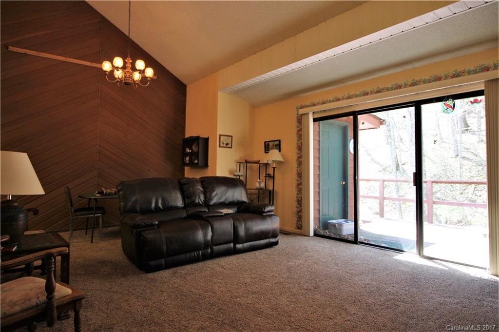 303 Riddle Cove Road, Unit 330 Maggie Valley, NC 28751 - Photo 6 of 24 a living room with furniture and a large window