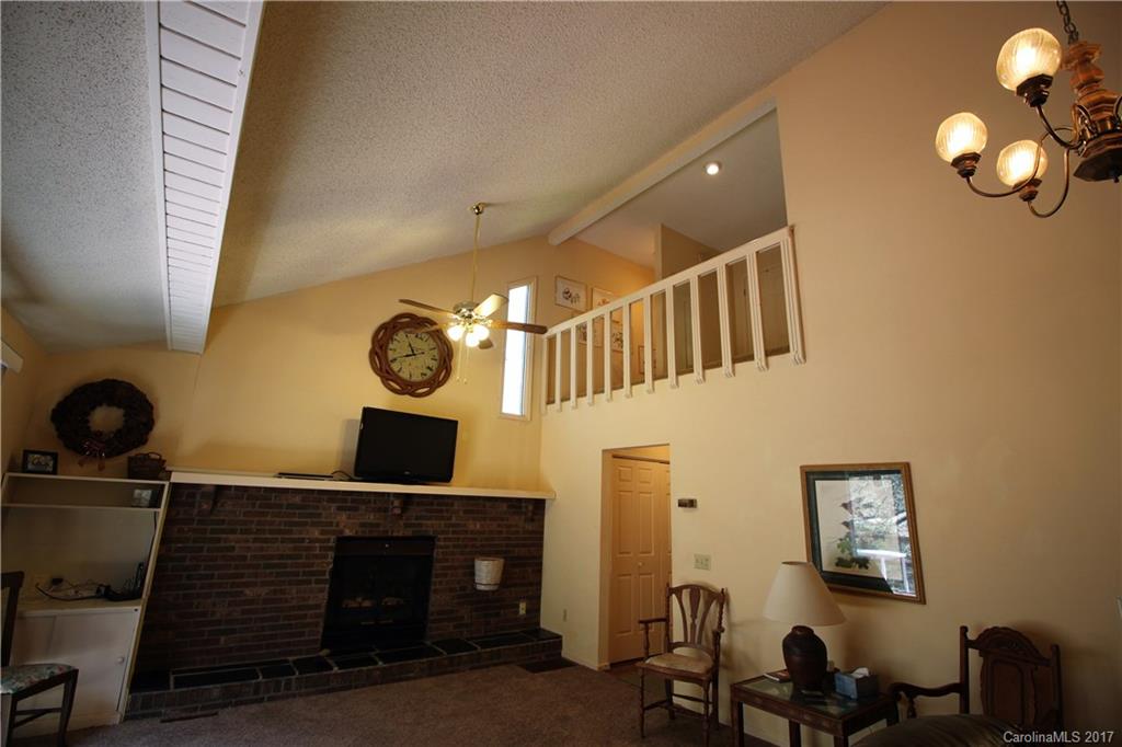 303 Riddle Cove Road, Unit 330 Maggie Valley, NC 28751 - Photo 7 of 24 a view of hall way with furniture and chandelier