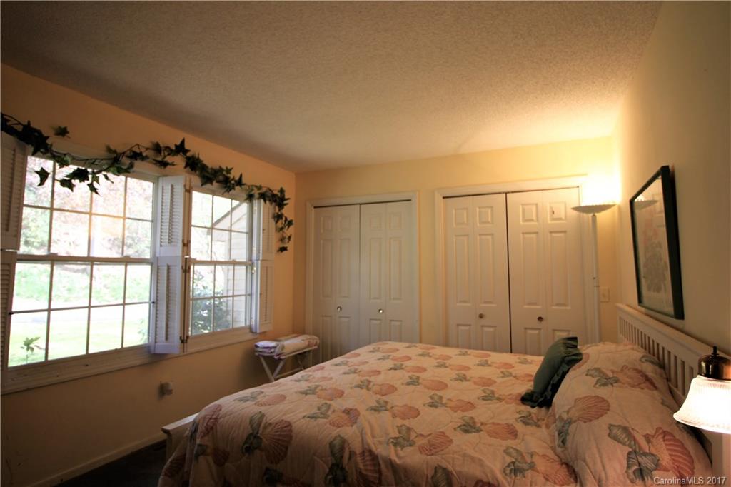 303 Riddle Cove Road, Unit 330 Maggie Valley, NC 28751 - Photo 9 of 24 a bedroom with a bed and a window