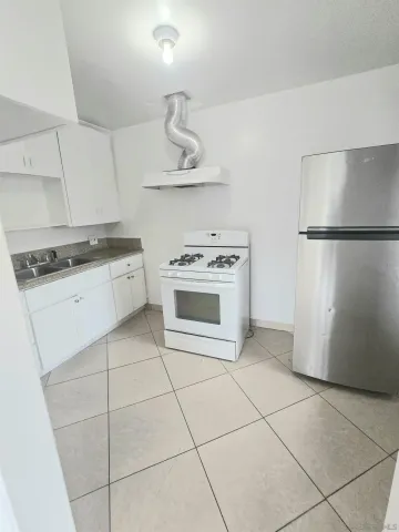 a kitchen with cabinets and steel stainless steel appliances