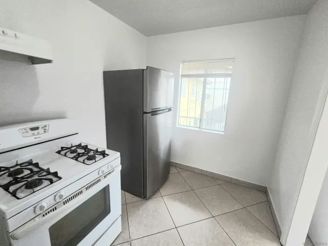 a kitchen with a stove a refrigerator and a stove