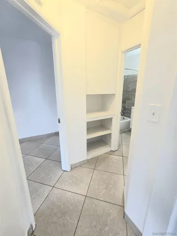 a view of walk in closet with empty racks