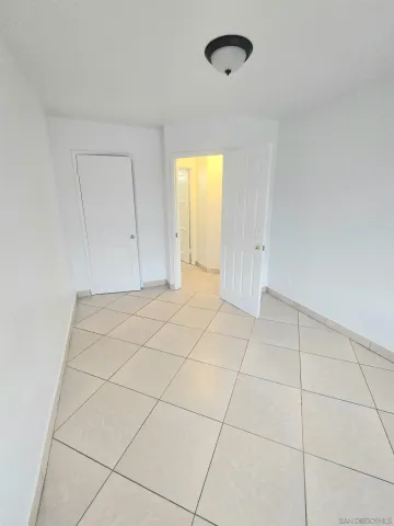 a view of a livingroom with an empty space and a window