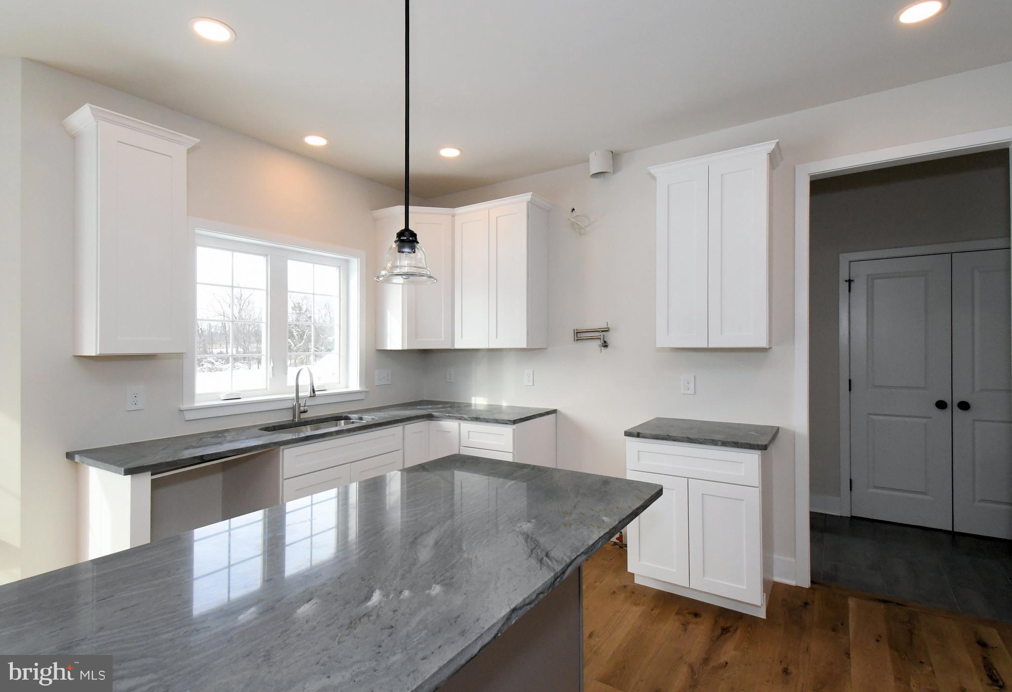 36 Hockle Road Schwenksville, PA 19473 - Photo 12 of 62 a kitchen with stainless steel appliances granite countertop a sink a stove and a wooden floors