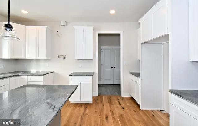 a kitchen with a sink a window and cabinets