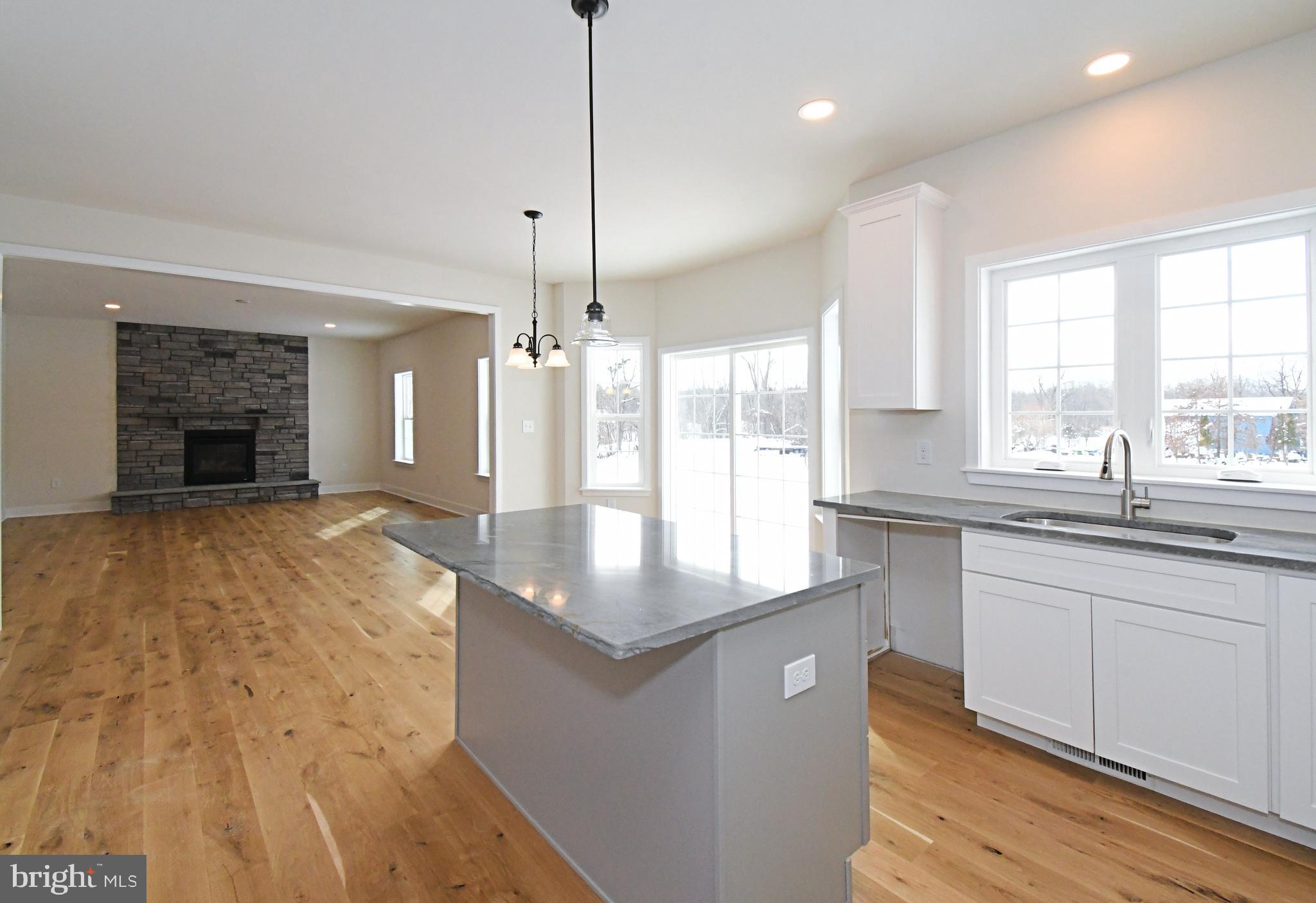 36 Hockle Road Schwenksville, PA 19473 - Photo 15 of 62 a kitchen with stainless steel appliances granite countertop a sink a stove and a wooden floors