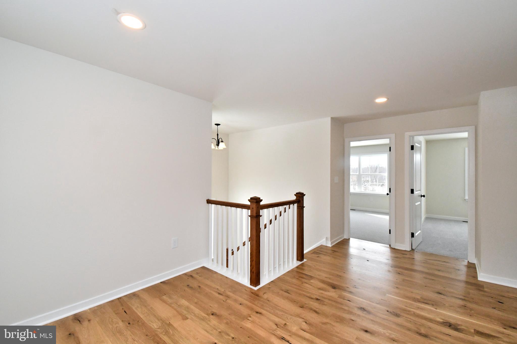 36 Hockle Road Schwenksville, PA 19473 - Photo 27 of 62 a view of a hallway with wooden floor