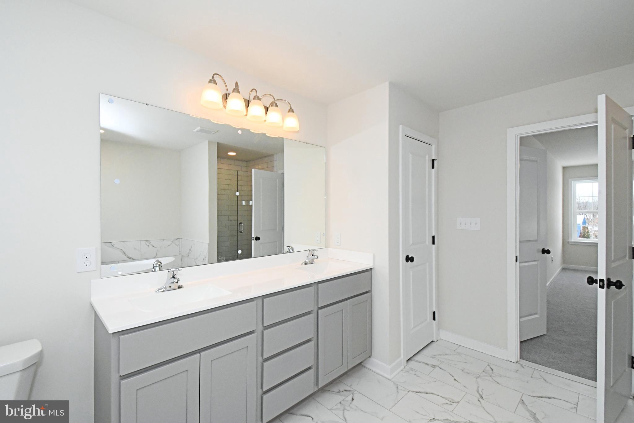 36 Hockle Road Schwenksville, PA 19473 - Photo 34 of 62 a bathroom with a sink double vanity and a mirror