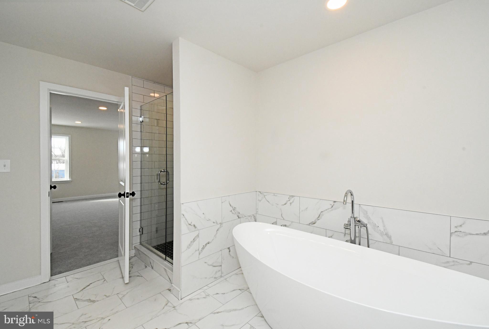 36 Hockle Road Schwenksville, PA 19473 - Photo 35 of 62 a bathroom with a bathtub and a shower