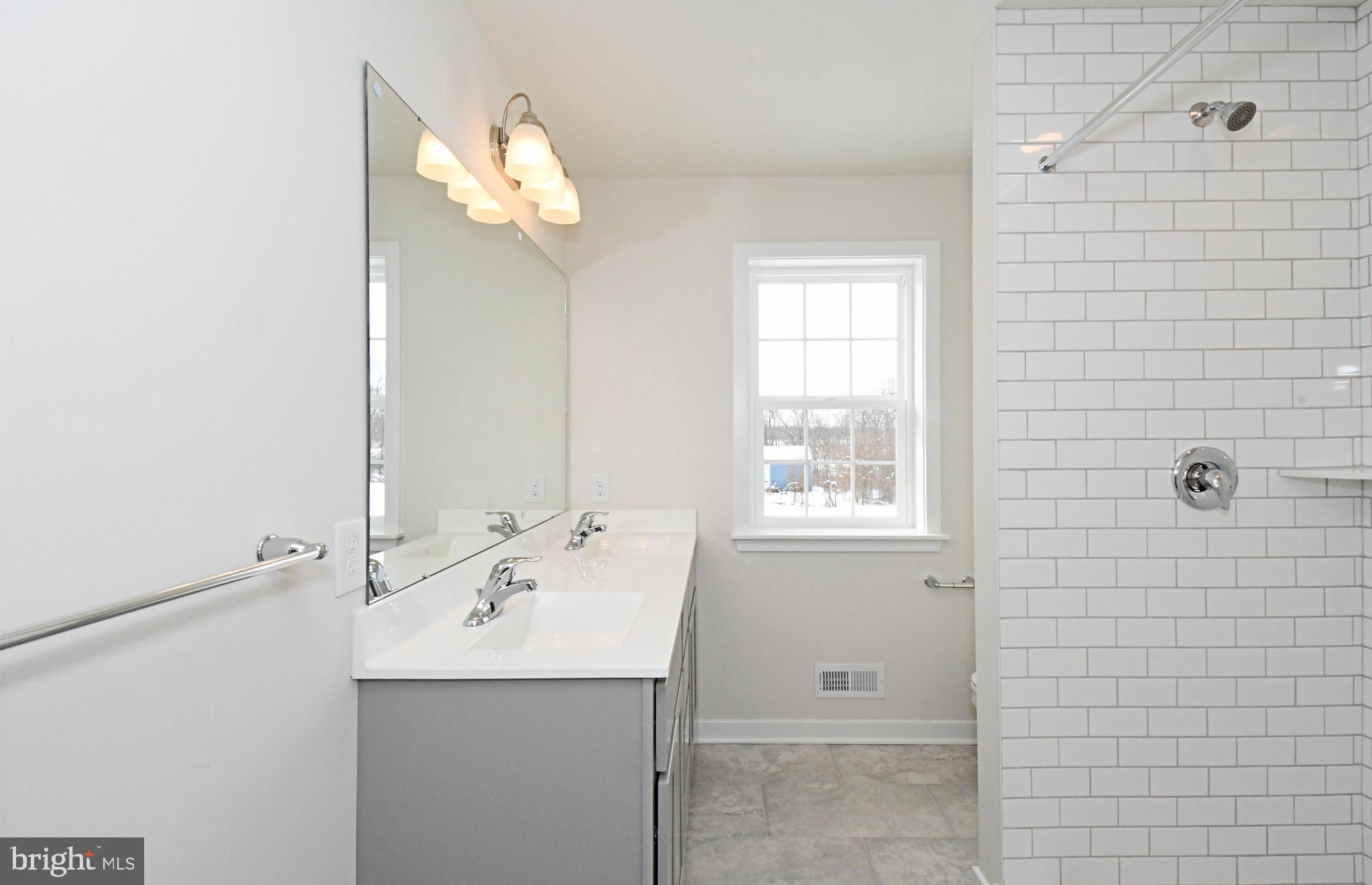 36 Hockle Road Schwenksville, PA 19473 - Photo 49 of 62 a bathroom with a sink a mirror and a shower