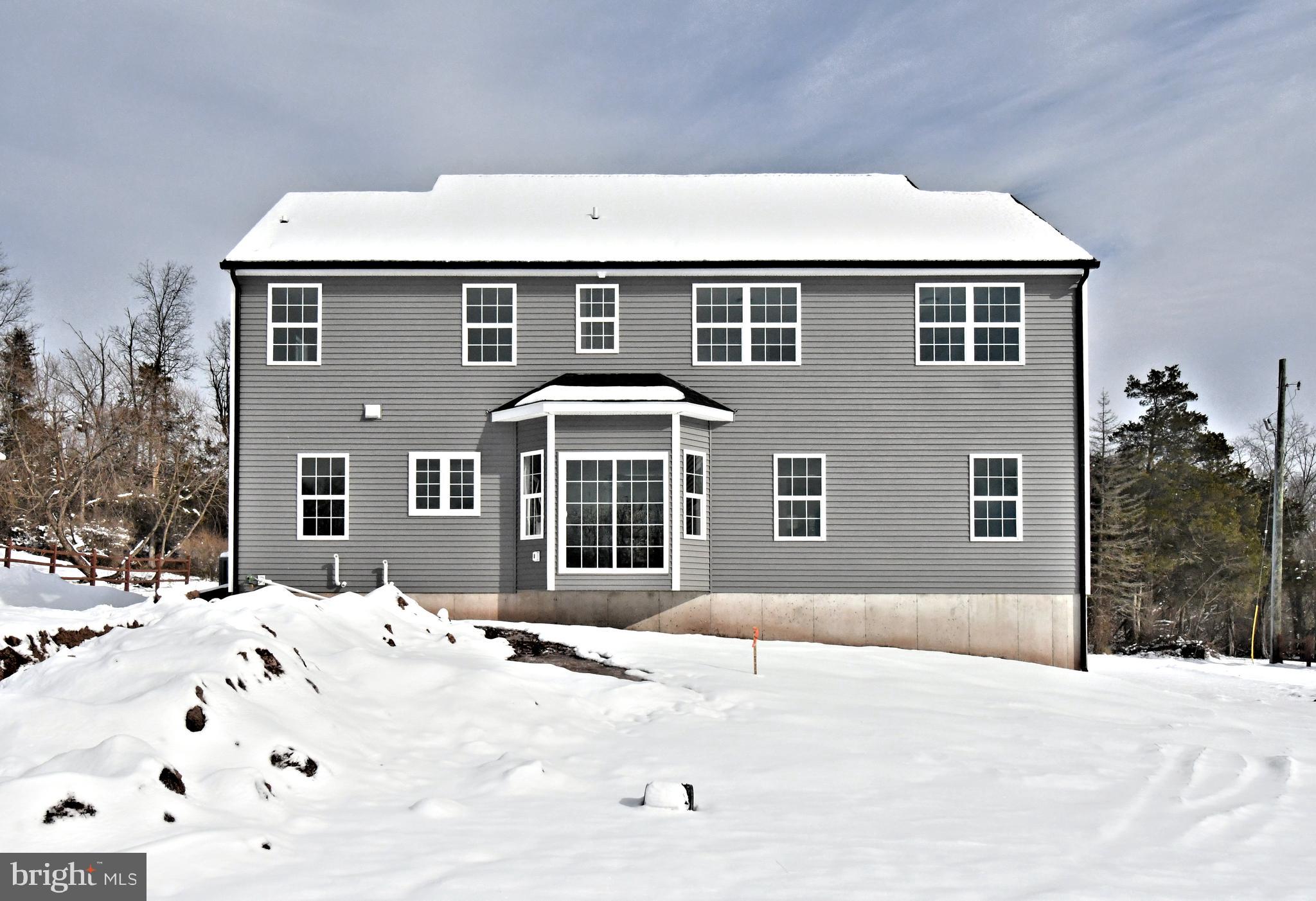 36 Hockle Road Schwenksville, PA 19473 - Photo 57 of 62 a front view of a house with a yard covered in snow