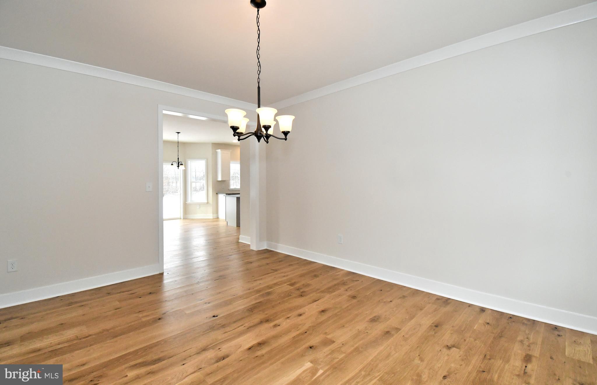 36 Hockle Road Schwenksville, PA 19473 - Photo 7 of 62 a view of an empty room with wooden floor and a chandelier