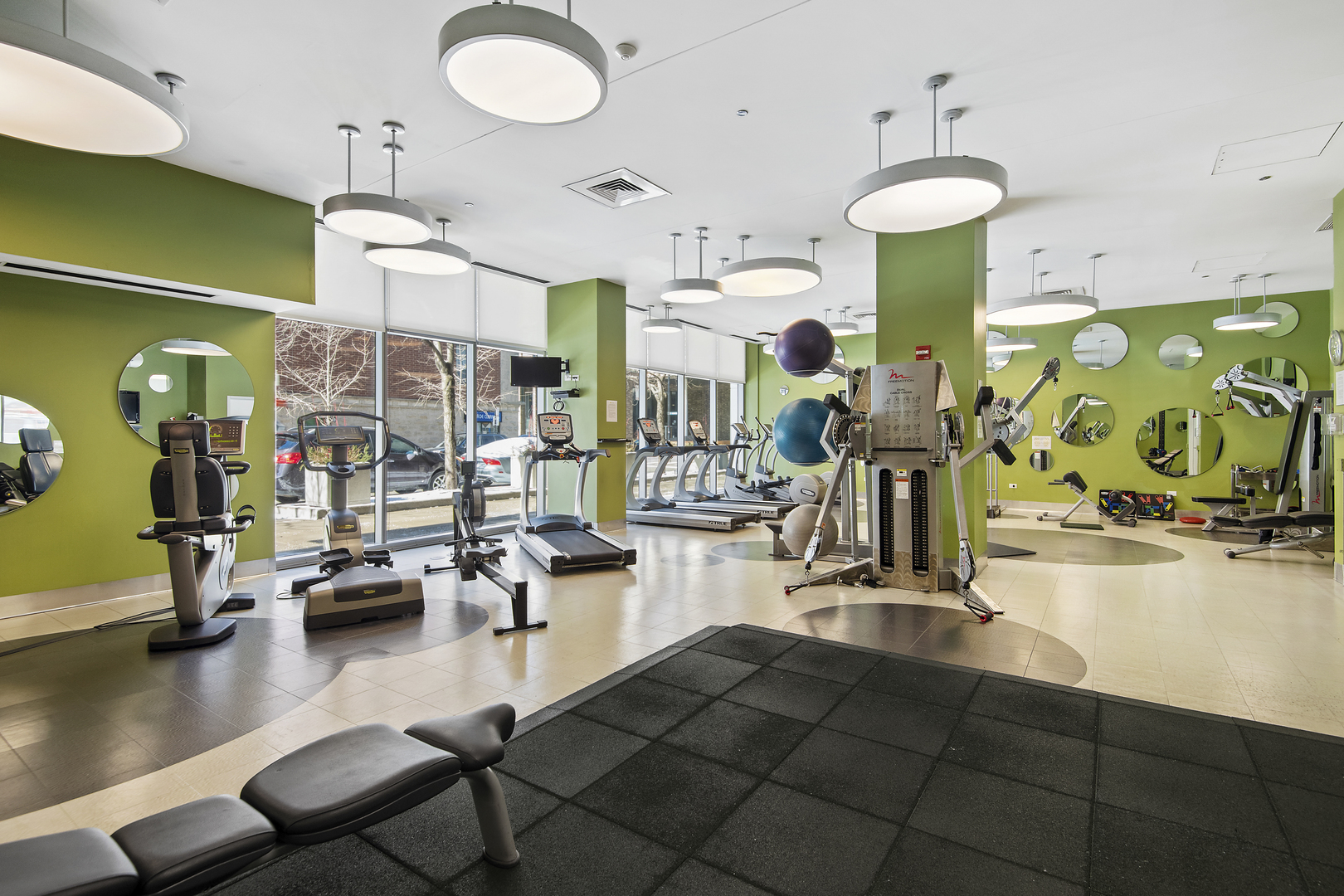 123 South Green Street, Unit 903B Chicago, IL 60607 - Photo 21 of 22 a gym room with gym equipment and a large window