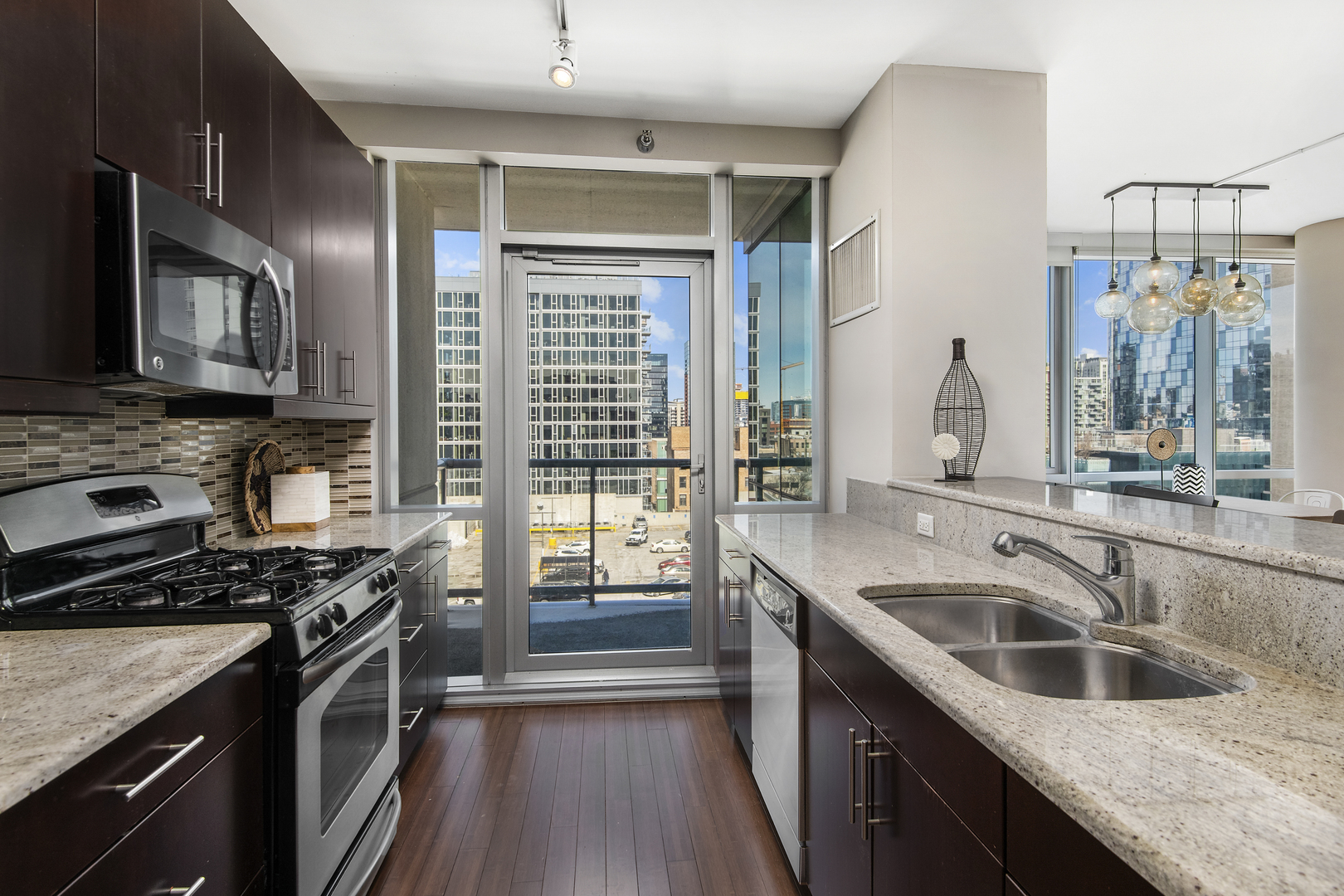 123 South Green Street, Unit 903B Chicago, IL 60607 - Photo 8 of 22 a kitchen that has a sink a stove and cabinets