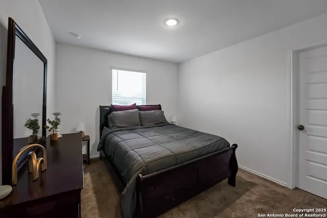 a bed sitting in a bedroom next to a window