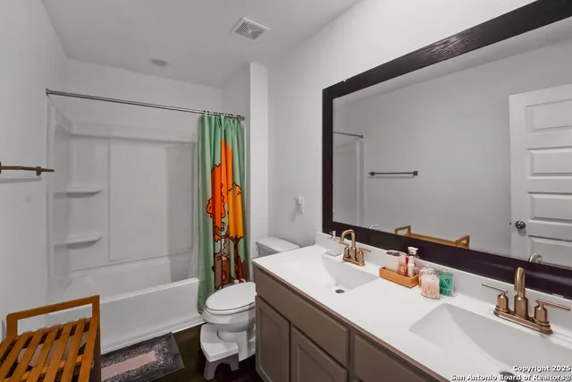 a bathroom with a sink toilet tub and shower