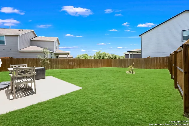 a view of a patio with a table and chairs