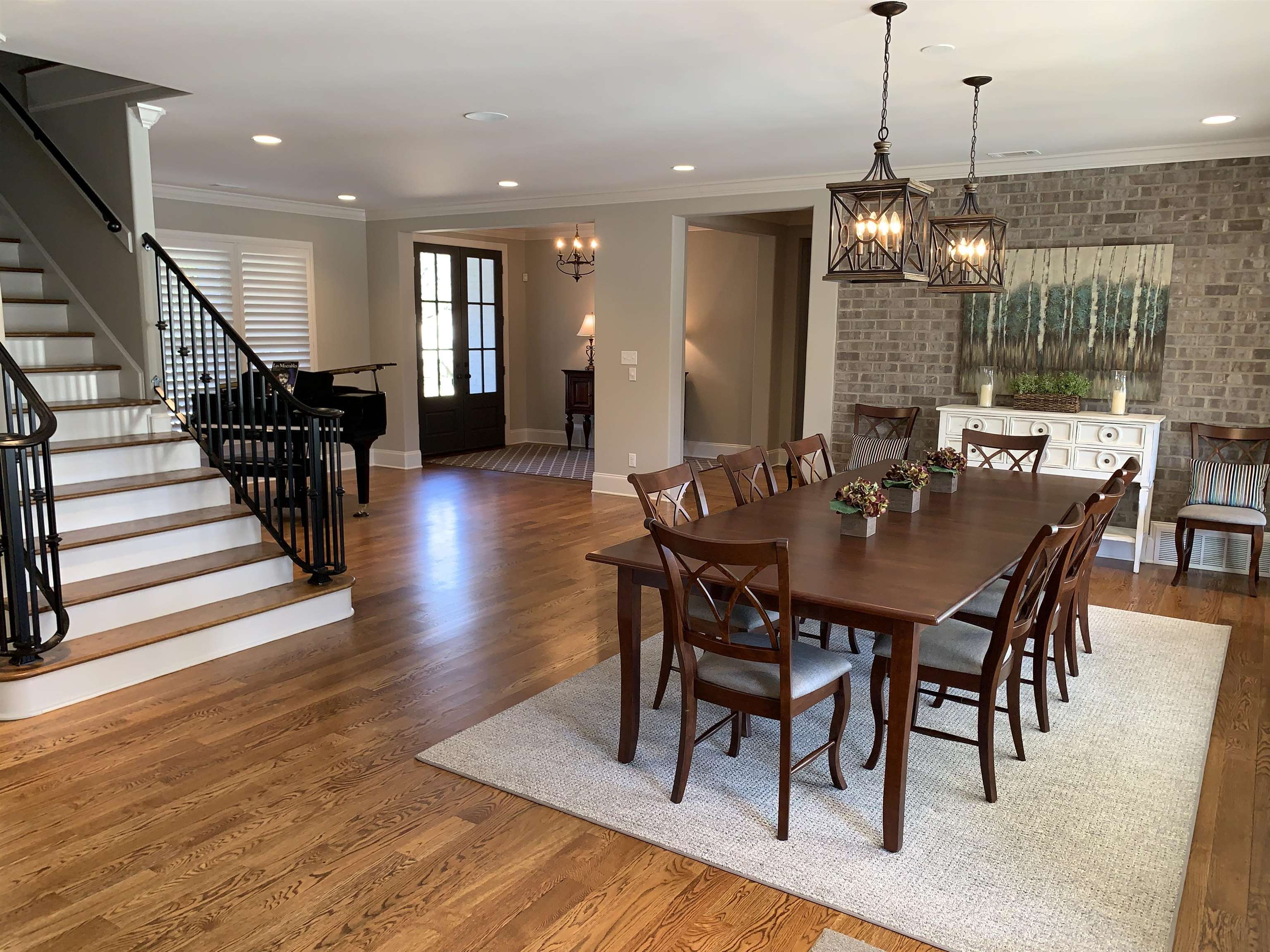 56 South Fernway Road Memphis, TN 38117 - Photo 4 of 25 a dining room with wooden floor a chandelier a wooden table and chairs