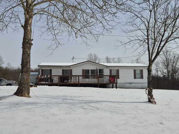 a view of a house with a snow in the yard