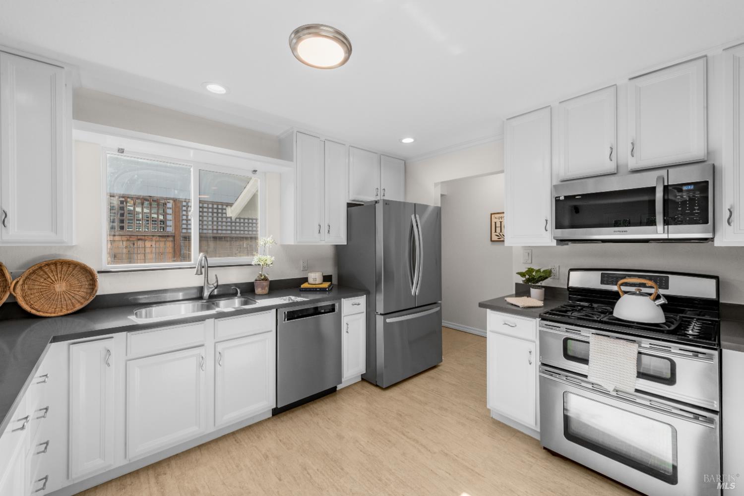 3996 Young Avenue Napa, CA 94558 - Photo 13 of 48 a kitchen with stainless steel appliances granite countertop a stove a sink and a refrigerator
