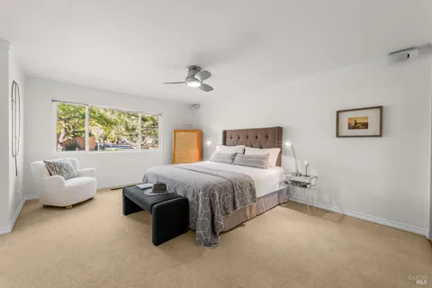 a spacious bedroom with a bed and window