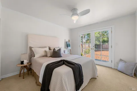 a bedroom with a large bed and a large window
