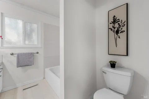 a white toilet sitting next to a bathroom sink