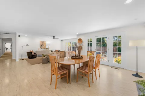 a view of a dining room with furniture and chandelier
