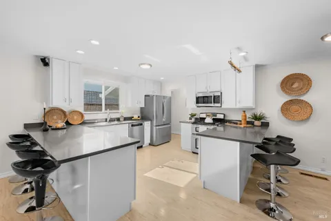 a kitchen with stainless steel appliances granite countertop a stove and a sink