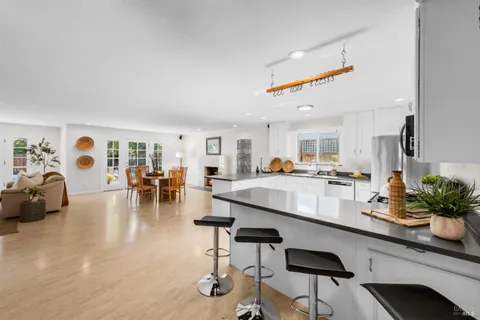 a view of a dining room with furniture and a kitchen