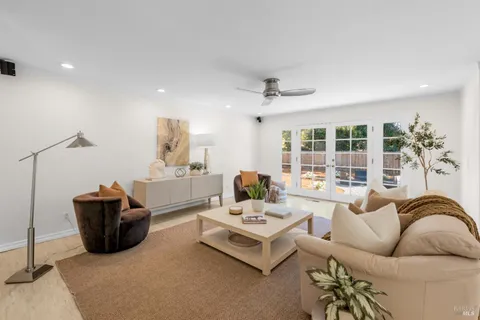 a living room with furniture ceiling fan and a rug