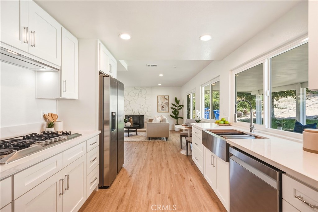 3343 Brookridge Road Duarte, CA 91010 - Photo 19 of 72 Chef’s kitchen with quartz countertops and backsplash, soft-close cabinetry, and an industrial-style faucet with upgraded accessories