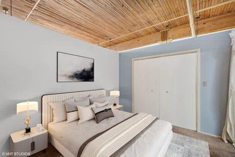 a bedroom with bed and cupboard