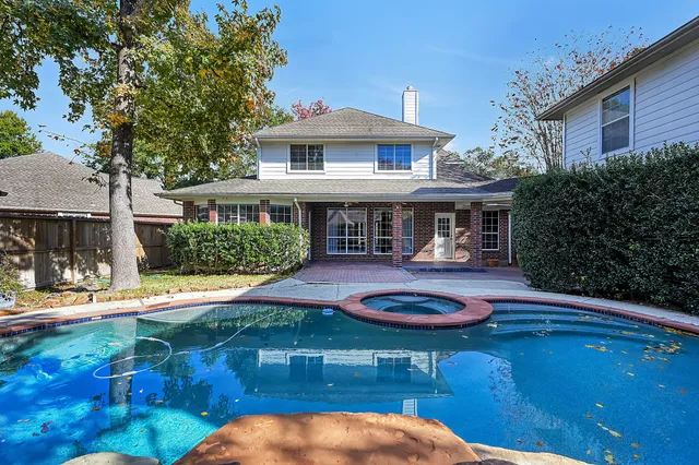 a swimming pool view with a seating space