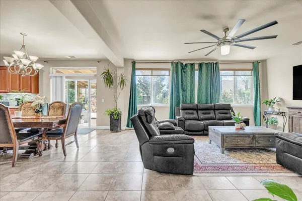 a living room with patio furniture and a chandelier