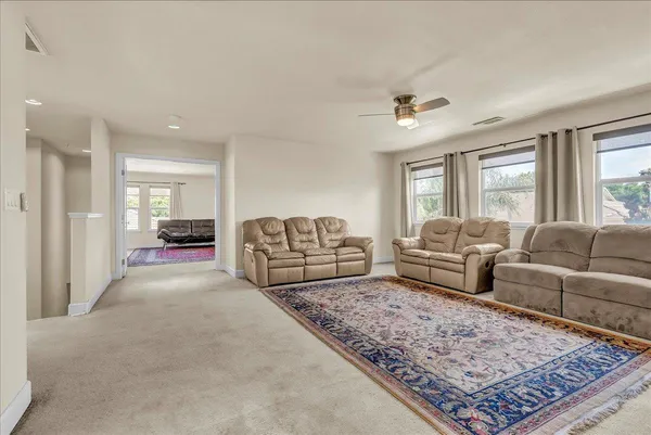 a living room with furniture and a rug