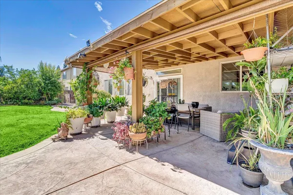 a view of a backyard with sitting area