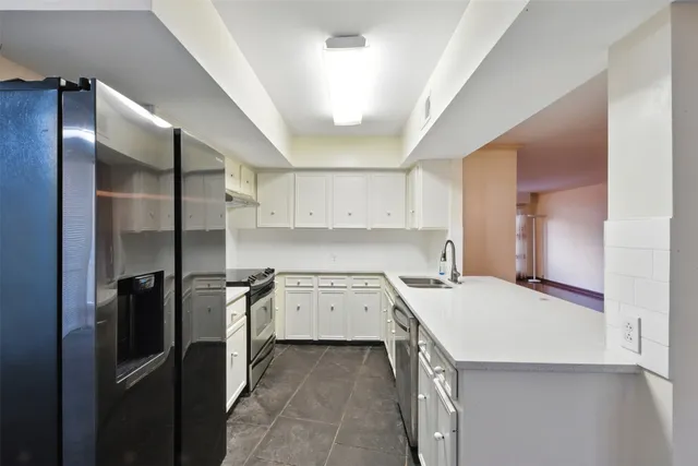 a kitchen with a sink stove and refrigerator