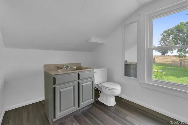 a view of bathroom with a toilet sink and a window